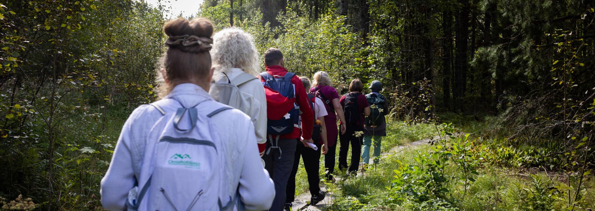 Vandrare på spångar med ryggen mot kameran.